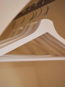a white stair case with a metal rail at Blu Bari in Bari +10 photos