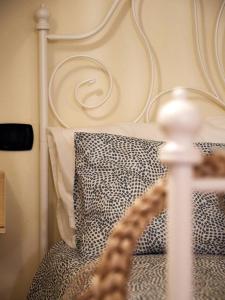 a bed with a white bed frame and a pillow at Blu Bari in Bari