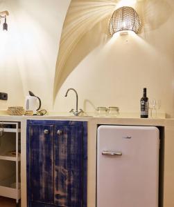 a kitchen with a sink and a refrigerator at Blu Bari in Bari