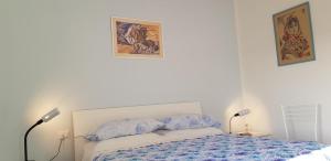 a bedroom with a bed and two pictures on the wall at SUL MARE... in Misano Adriatico