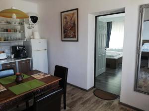 a kitchen and dining room with a table and a refrigerator at Casa Ago - Guest House in Păuliş +24 photos