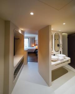 a bathroom with two sinks and a large mirror at Pacha Hotel in Ibiza Town