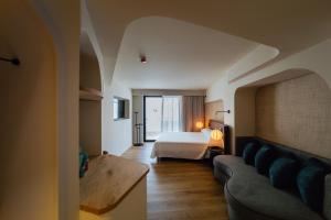 a hotel room with a bed and a couch at Pacha Hotel in Ibiza Town