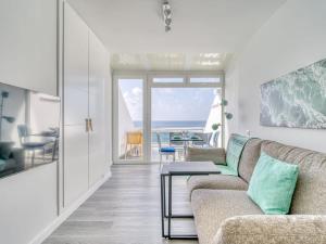 a living room with a couch and a table at Luxury Suite Over The Beach in Las Palmas de Gran Canaria