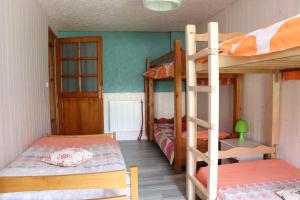 a bedroom with two bunk beds and a ladder at GITE DES FUVES in Luisans