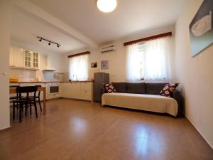 a living room with a couch and a kitchen at Brna Three-room apartment near the beach-Zen in Brna