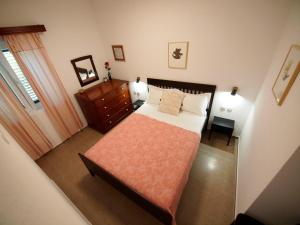 a bedroom with a bed and a dresser and a mirror at Brna Three-room apartment near the beach-Zen in Brna