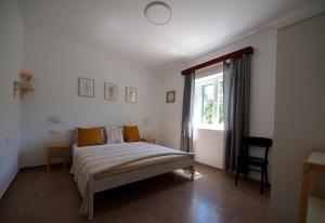 a bedroom with a bed and a window at Brna Three-room apartment near the beach-Zen in Brna