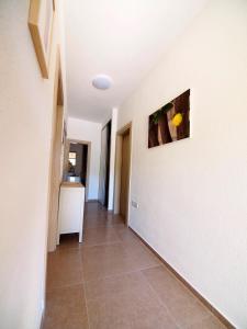 a hallway with a tile floor and a painting on the wall at Brna Three-room apartment near the beach-Zen in Brna