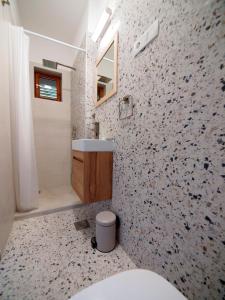 a bathroom with a sink and a toilet in it at Brna Three-room apartment near the beach-Zen in Brna +31 photos