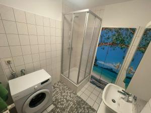 a bathroom with a shower and a toilet and a sink at Richter Apartments 3 in Finsterwalde