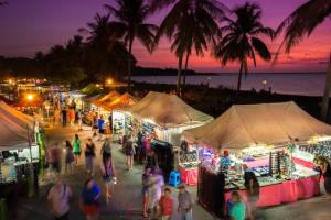 a group of people walking around a market at night at Top End Marvel -Darwin's Premier 3-BR Luxury Apt in Darwin +22 photos