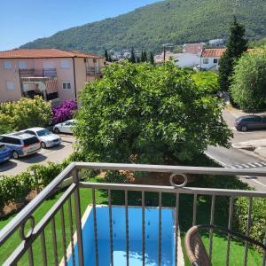 a balcony with a view of a parking lot at Apartmani Mia Sorajic in Petrovac na Moru