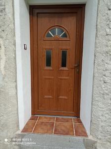 a wooden door on a building with a tile floor at Apartmány u Bečova nad Teplou in Bečov nad Teplou