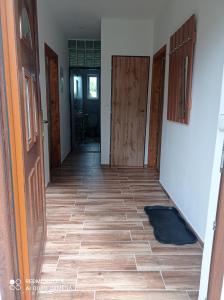 a hallway with doors and a tile floor at Apartmány u Bečova nad Teplou in Bečov nad Teplou