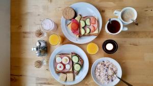 a wooden table with two plates of food and coffee at Hotel Natur Akureyri in Akureyri