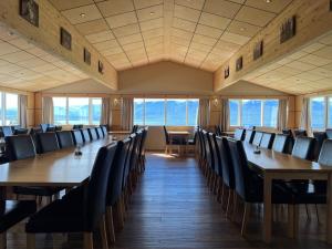a conference room with wooden tables and chairs at Hotel Natur Akureyri in Akureyri