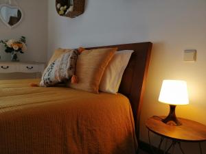 a bedroom with a bed with a lamp on it at Casa da Pedralva in Nazaré