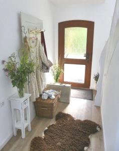 a living room with a door and a rug at Haus Heimatliebe in Obernheim