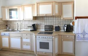 a kitchen with white cabinets and a white stove top oven at Haus Heimatliebe in Obernheim