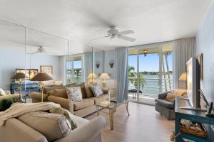 a living room with a couch and a tv in it at Bahia Vista 8-314, 2 Bedroom, Heated Pool, Spa, WiFi, Sleeps 6 in St. Petersburg