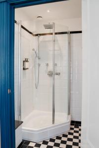 a bathroom with a shower with a tub at Paleis Hotel in The Hague