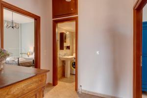 a kitchen with a mirror and a bathroom with a sink at Vera Vista Syros in Ano Syros