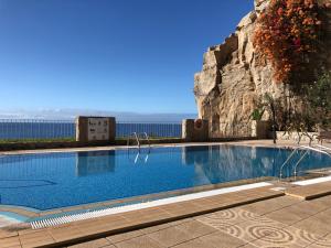 a swimming pool with the ocean in the background at Four Seasons - Playa del Cura in Playa del Cura