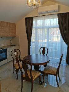 a dining room with a table and chairs and a window at Beach Lounge Luxory Apartments in Klaipėda