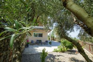 a view of a house through a tree at La Pietra Verga in Kalamata