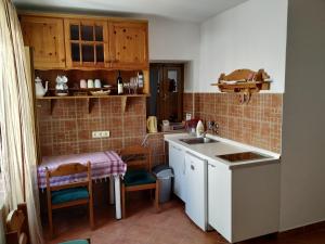 a small kitchen with a sink and a table at Apartment Katarina in Risan +27 photos