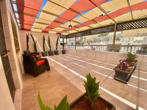 an empty lobby with a colorful ceiling and plants at Villa Mira GuestHouse 2 - Downtown Central Amman - AL DIYRIH in Amman