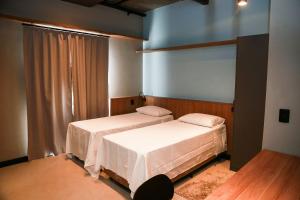 Una cama o camas en una habitación de Globo Lar Studios