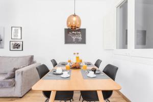 a dining room with a wooden table and chairs at Cozy Apartment close to Passeig de Gracia in Barcelona