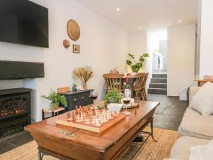 a living room with a chessboard on a wooden table at Sandacre Cottage in Ulverston