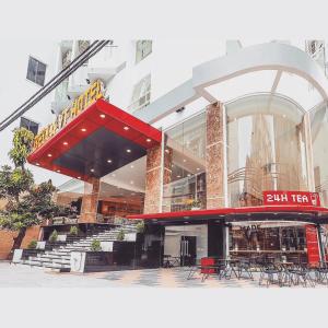 a building with a restaurant with a red roof at BELLA VT HOTEL in Vung Tau