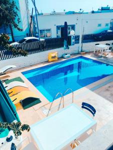 a swimming pool with a table and chairs next to it at EXEN BY WEEKEND in Bodrum City