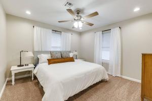 a bedroom with a white bed and a ceiling fan at 3 BR Newly Remodeled Home With Farm Style Decor in Oklahoma City