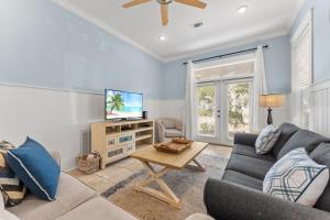 a living room with a couch and a tv at Aquanut Beach House 30A in Inlet Beach