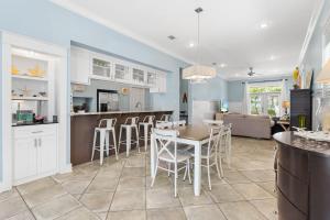 a kitchen and living room with a table and chairs at Aquanut Beach House 30A in Inlet Beach