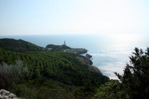 a lighthouse on a hill next to the ocean at Hotel Al Mulino in Anacapri