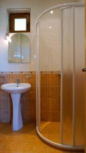 a bathroom with a shower and a sink at Вила Роза - Villa Rosa in Bŭlgarevo