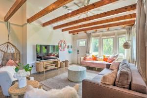a living room with a couch and a table at Hutchinson Island Cottage Steps to the Beach in Fort Pierce