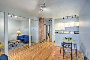 a living room and kitchen with a table and chairs at 3 Mi to Dtwn Walkable Apt in Cleveland! in Cleveland