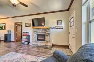 a living room with a fireplace and a flat screen tv at Cozy Townsend Condo, Resort-Style Amenities! in Townsend