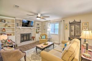 a living room with a couch and a fireplace at Bright Tallahassee Retreat with Lanai and Yard! in Tallahassee