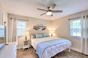 a bedroom with a bed and a ceiling fan at about 8 Mi to FSU Bright Tallahassee Retreat! in Tallahassee
