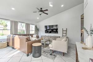 a living room with a couch and a table at Beautiful Chandler Escape with Putting Green and Pool! in Chandler