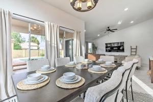 a dining room and living room with a table and chairs at Beautiful Chandler Escape with Putting Green and Pool! in Chandler