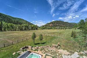 an outdoor bath tub in a field with mountains at Fish Creek Ranch in Dolores Hot Tub and Game Room in Dolores